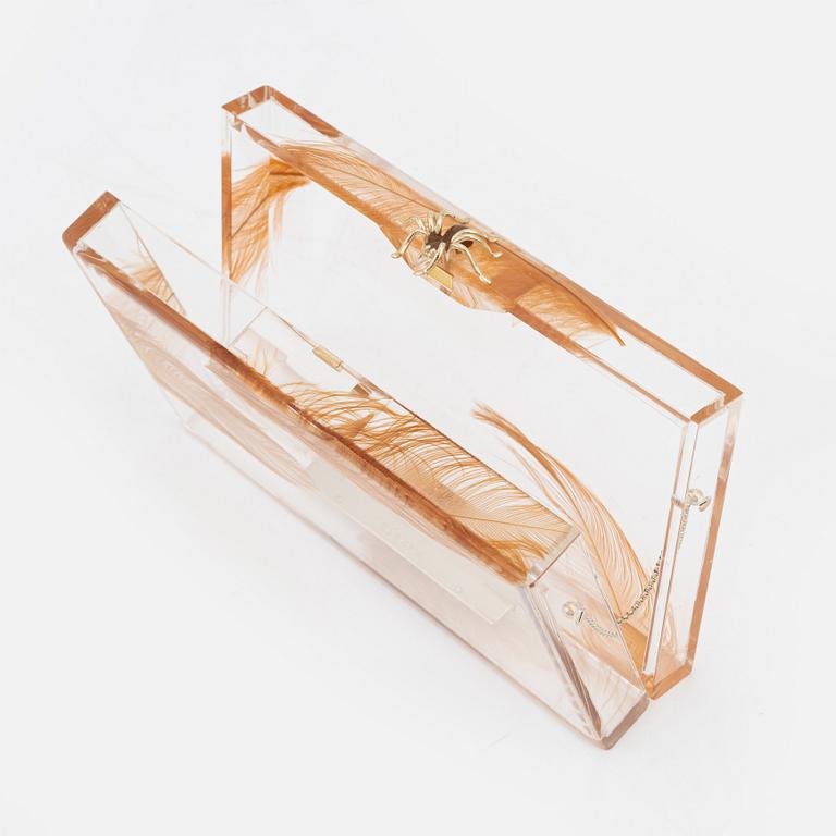 Charlotte Olympia, a transparent clutch with feathers and a spider.