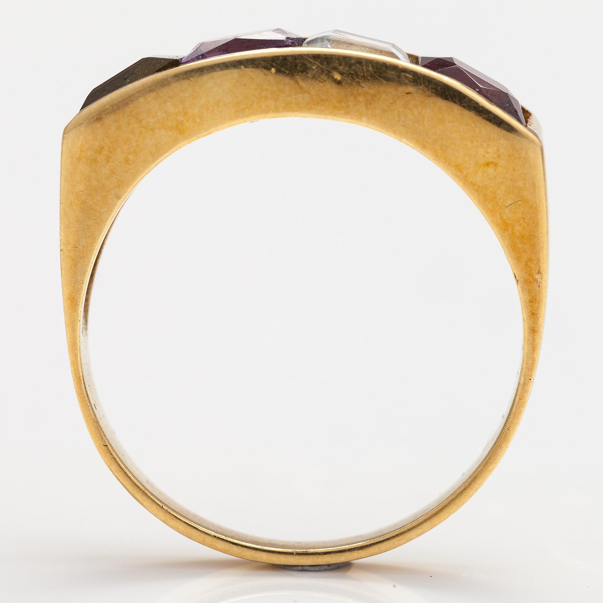 An 18K gold ring with an amethyst, garnet, topaz and peridote.