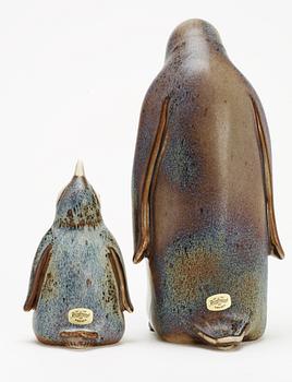 Two Gunnar Nylund stoneware figures depicting a penguin mother with child, Rörstrand.