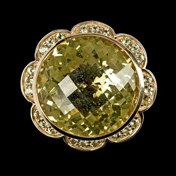 1166. RING, large faceted citrine with smaller peridotes.