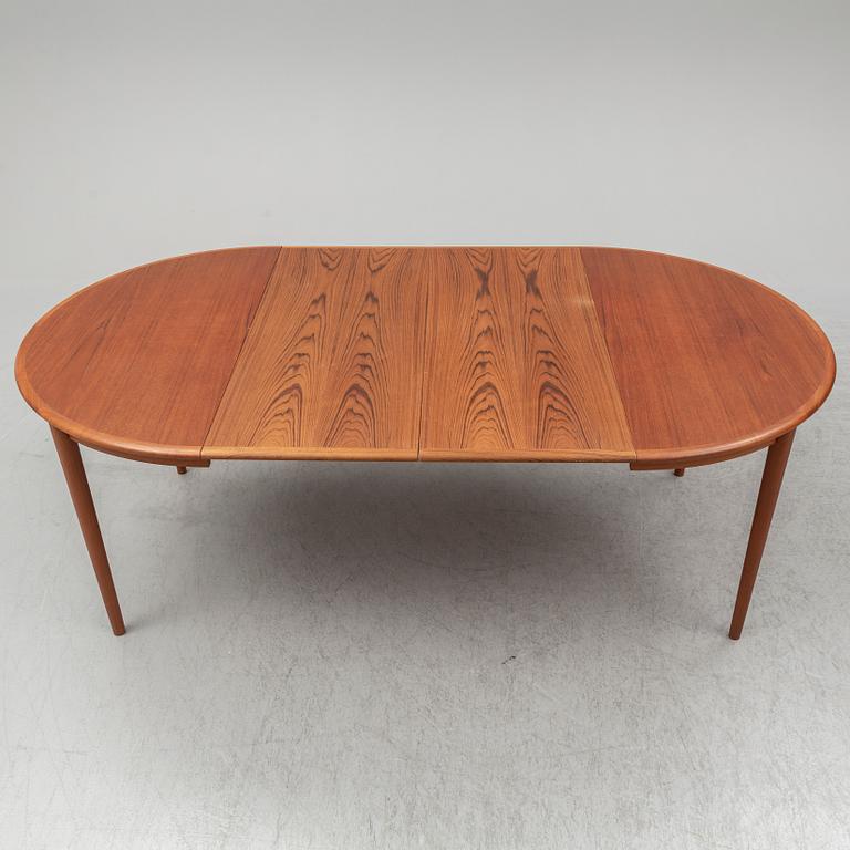 A 1960s teak veneered dining table.