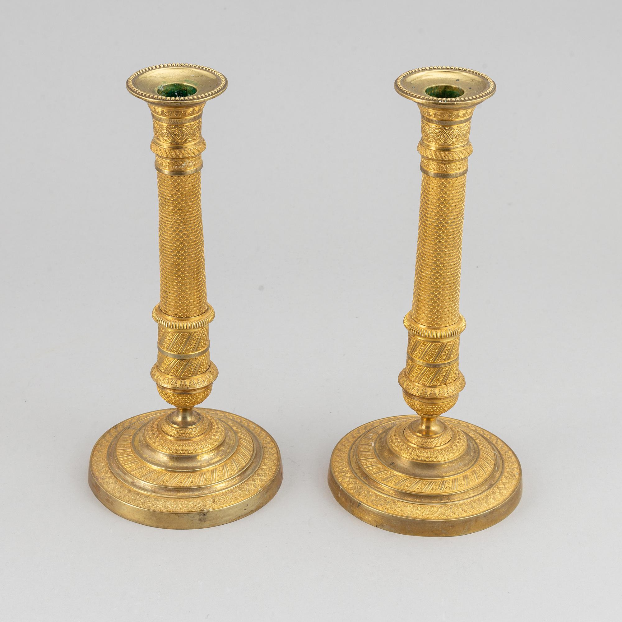 An early 19th Century pair of bronze empire candle sticks.