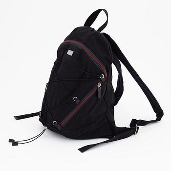 Gucci, a black canvas backpack.