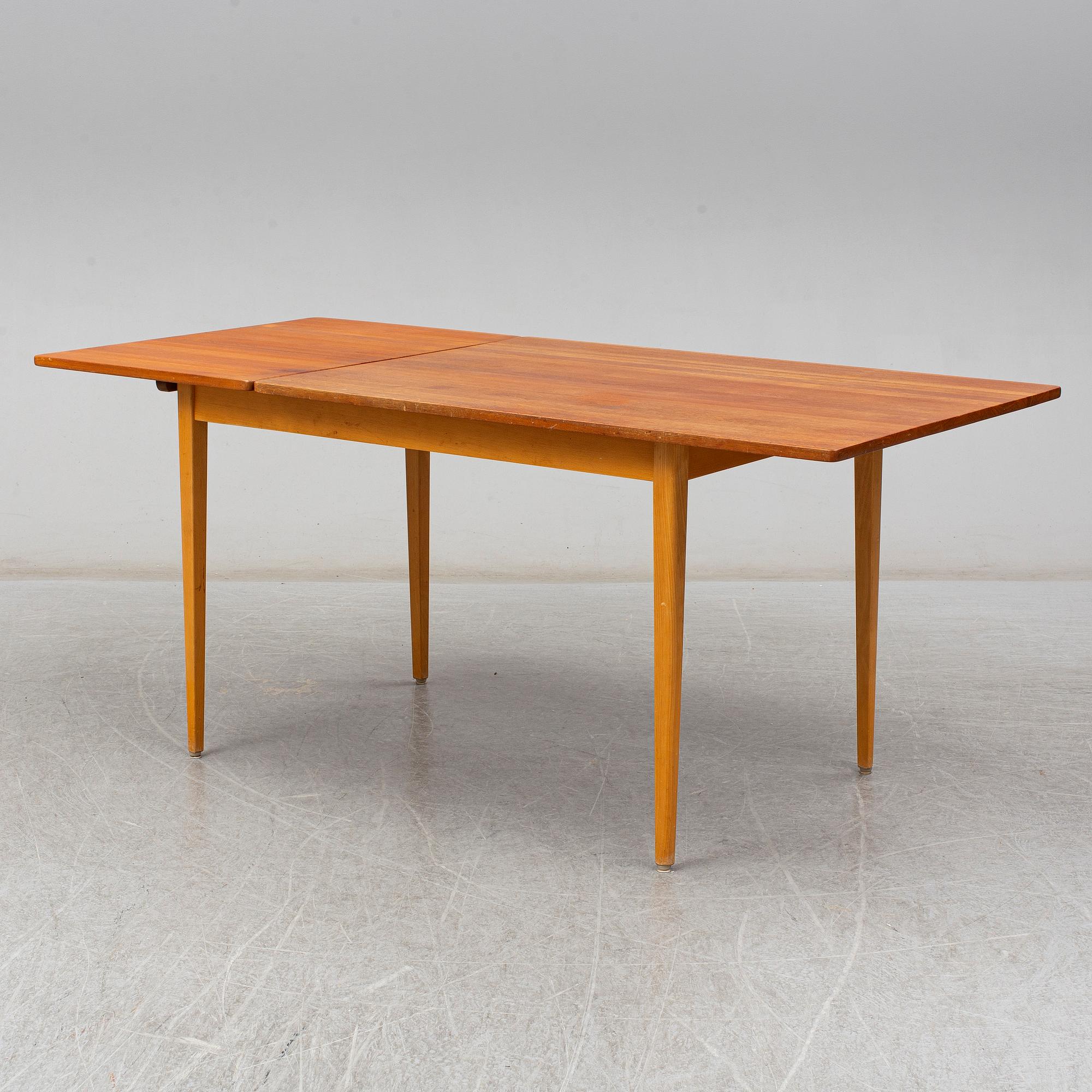 A 1960s teak veneered dining table.