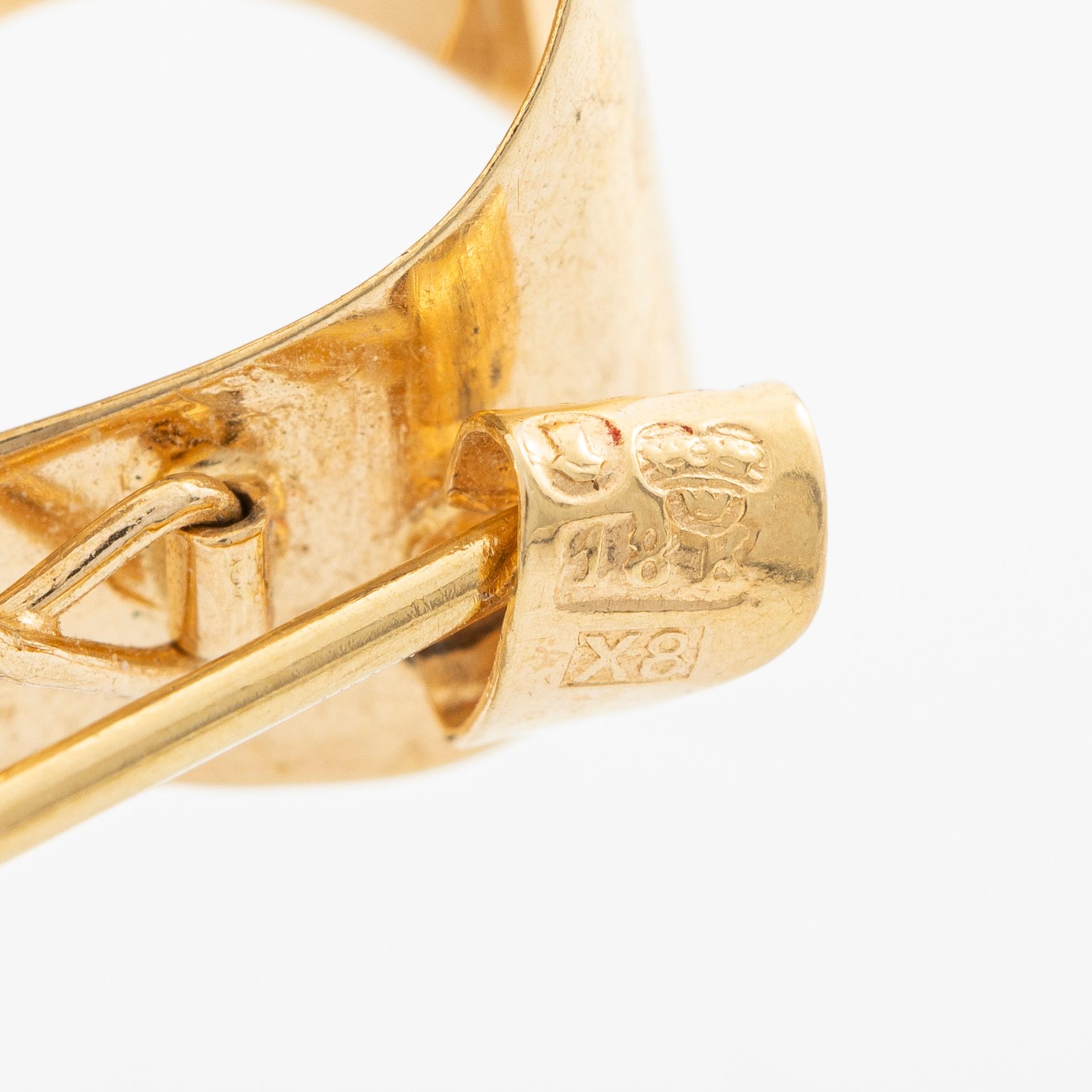 Brooch, 18K gold in the form of a bowknot.