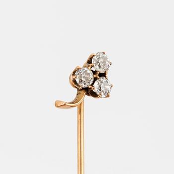 A TIE-PIN, 14K gold with three old cut diamonds.
