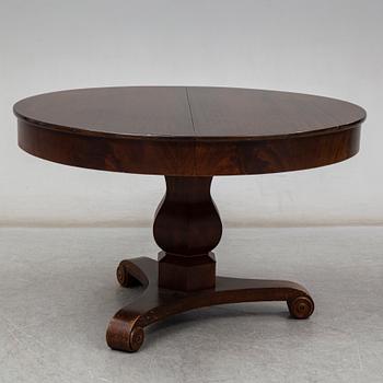 a mid 1800's mahogany dining table with three leaves.