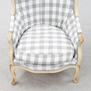 A Rococo-Style Bergère Easy Chair, first half of the 20th century.