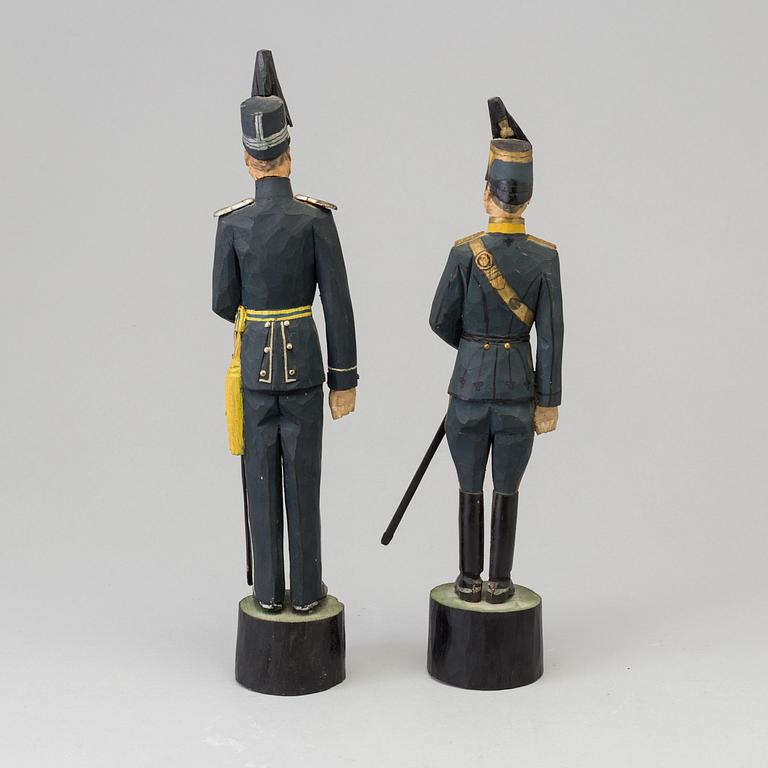 Two wooden sculptures depicting Swedish officers, signed and daterd 1939.