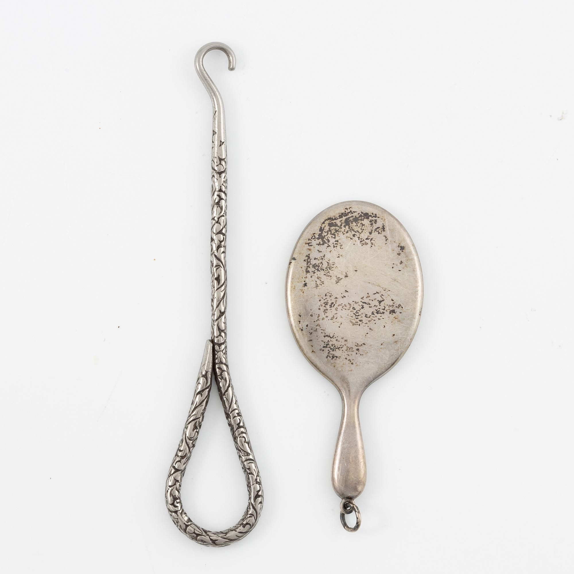 Two brushes, a hook, and a small mirror, silver and nickel silver.