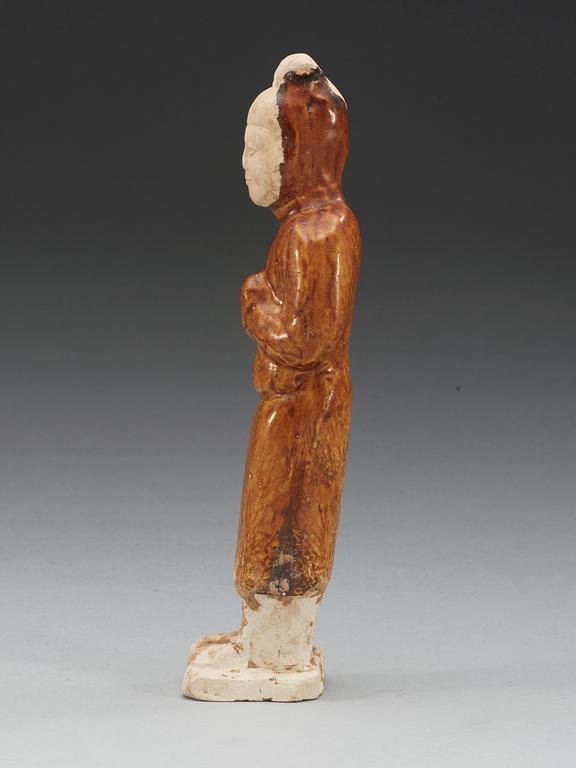 A yellow glazed pottery figure of a court attendant, Sui dynasty (589-618).