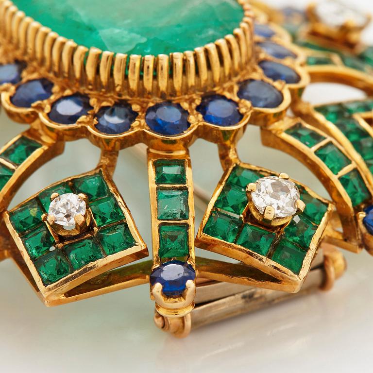 An 18K gold brooch set with an oval emerald and old cut diamonds.