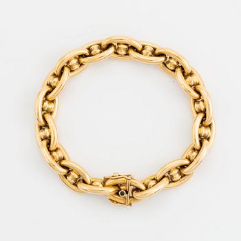 An 18K gold bracelet.