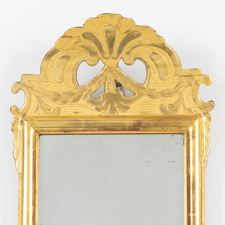 A giltwood rococo mirror by J. Schürer (master in Stockholm 1769).