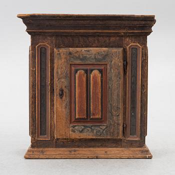 A polychrome-painted folk art hanging cabinet from Järvsö, Sweden, early 19th century.