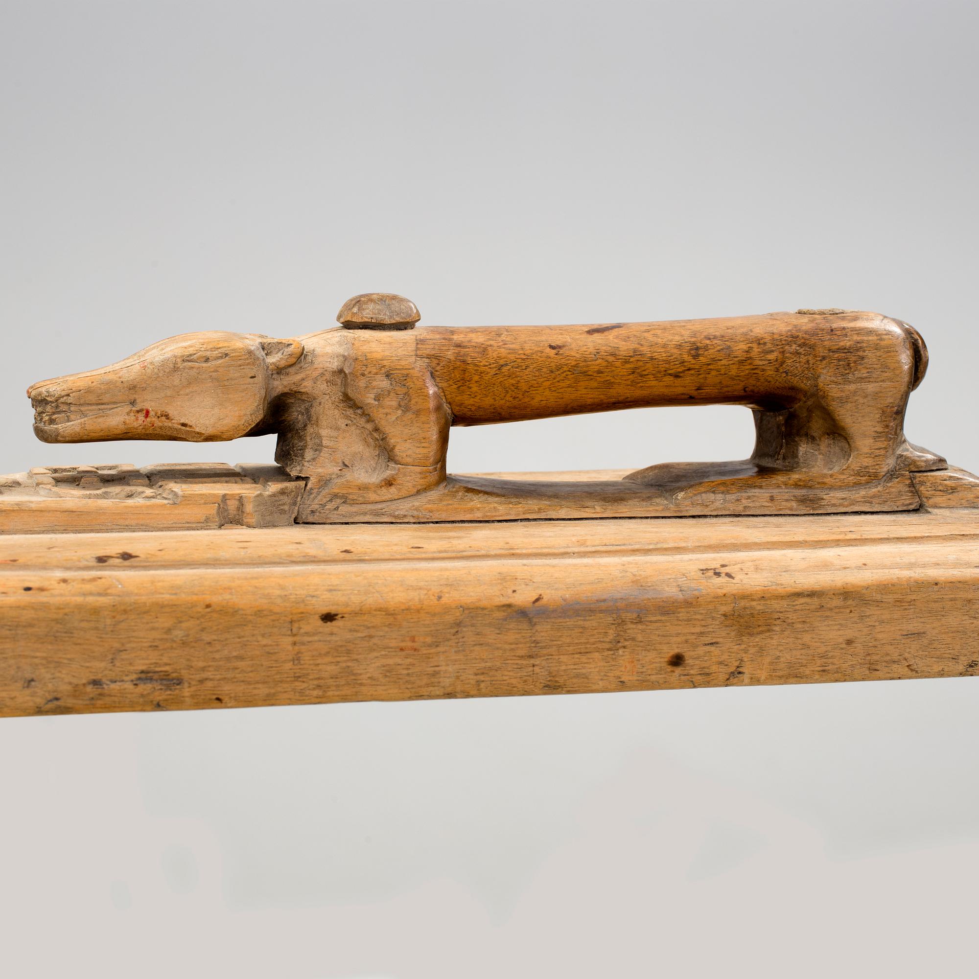 A Swedish folk art mangle board with carved decorationd, owners' initials and the date 1744.