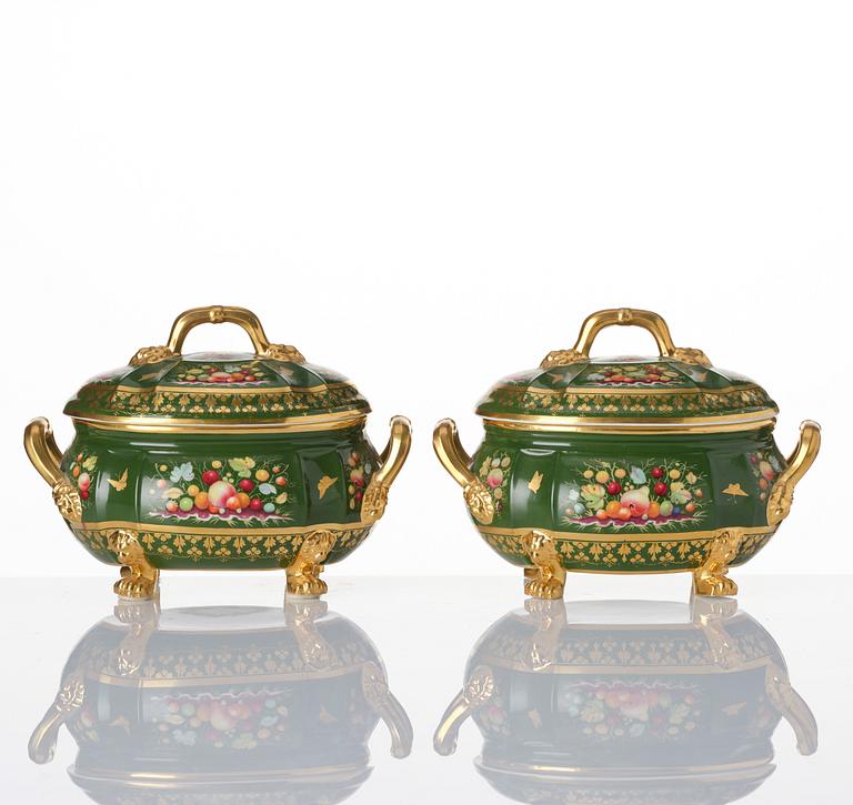 A pair of armorial butter tureens with covers and stands and two fruit dishes, Derby, England, circa 1830.