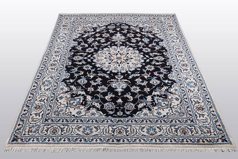 A rug, Nain, part silk, ca 242 x 167 cm.