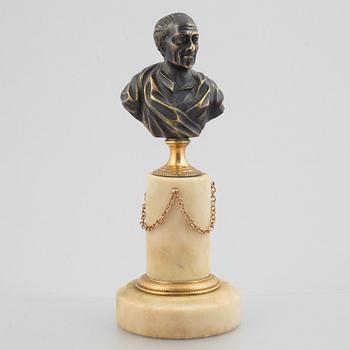 A Louis XVI patinated bronze and marble library bust of Voltaire, late 18th century.