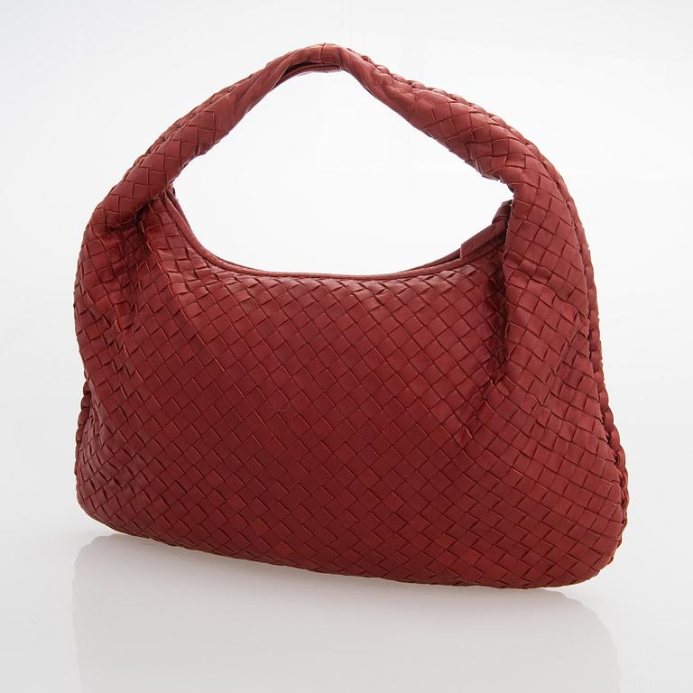 Bottega Veneta, a red leather 'Veneta' Bag.