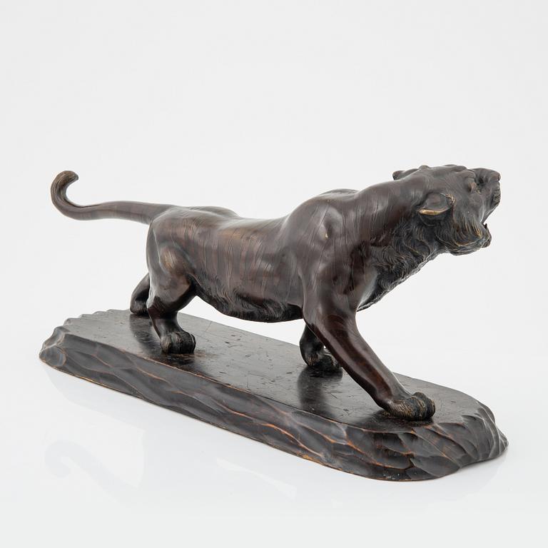 A Japanese sculpture of a tiger, 20th Century.