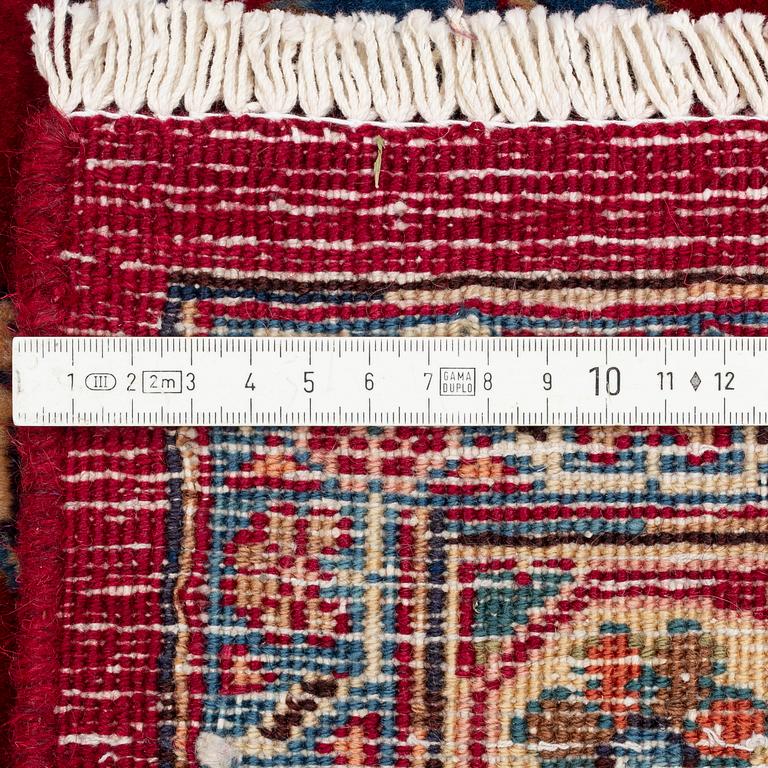 A Mashad carpet, approximately 344 x 245 cm.