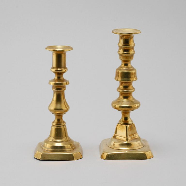 Eight late 19th century brass candlesticks.