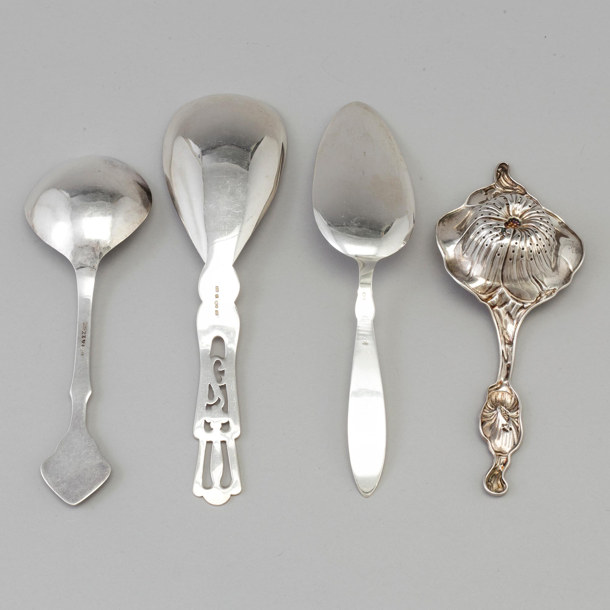 Three Art Nouveau silver serving spoons, one with maker's mark Emil O. Möller, Malmö, Sweden 1935 and a tea strainer, US.