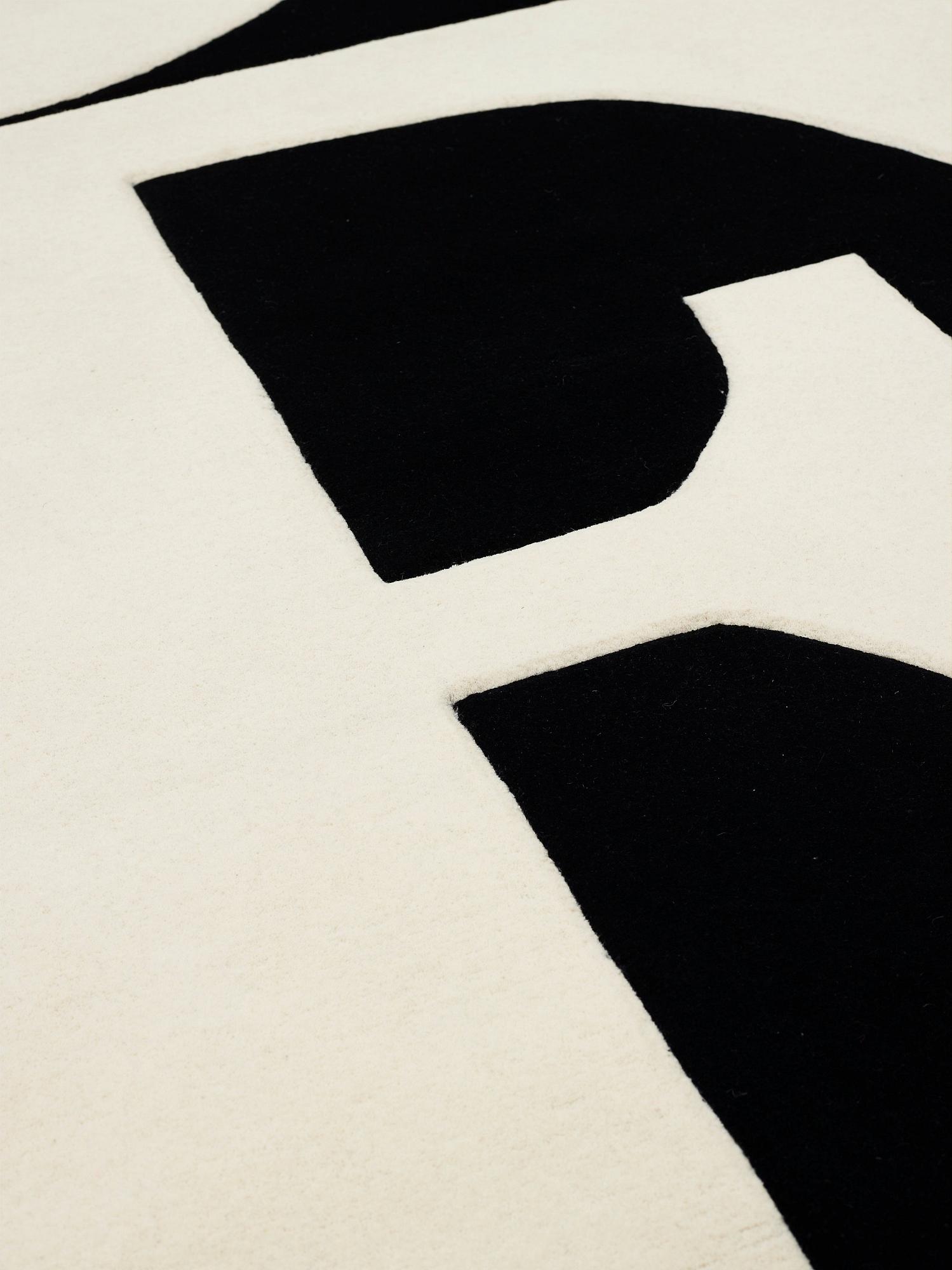 Robert Indiana, A CARPET, "White on Black", Chosen Love, hand tufted in 1995, ca 302 x 305 cm, Robert Indiana.
