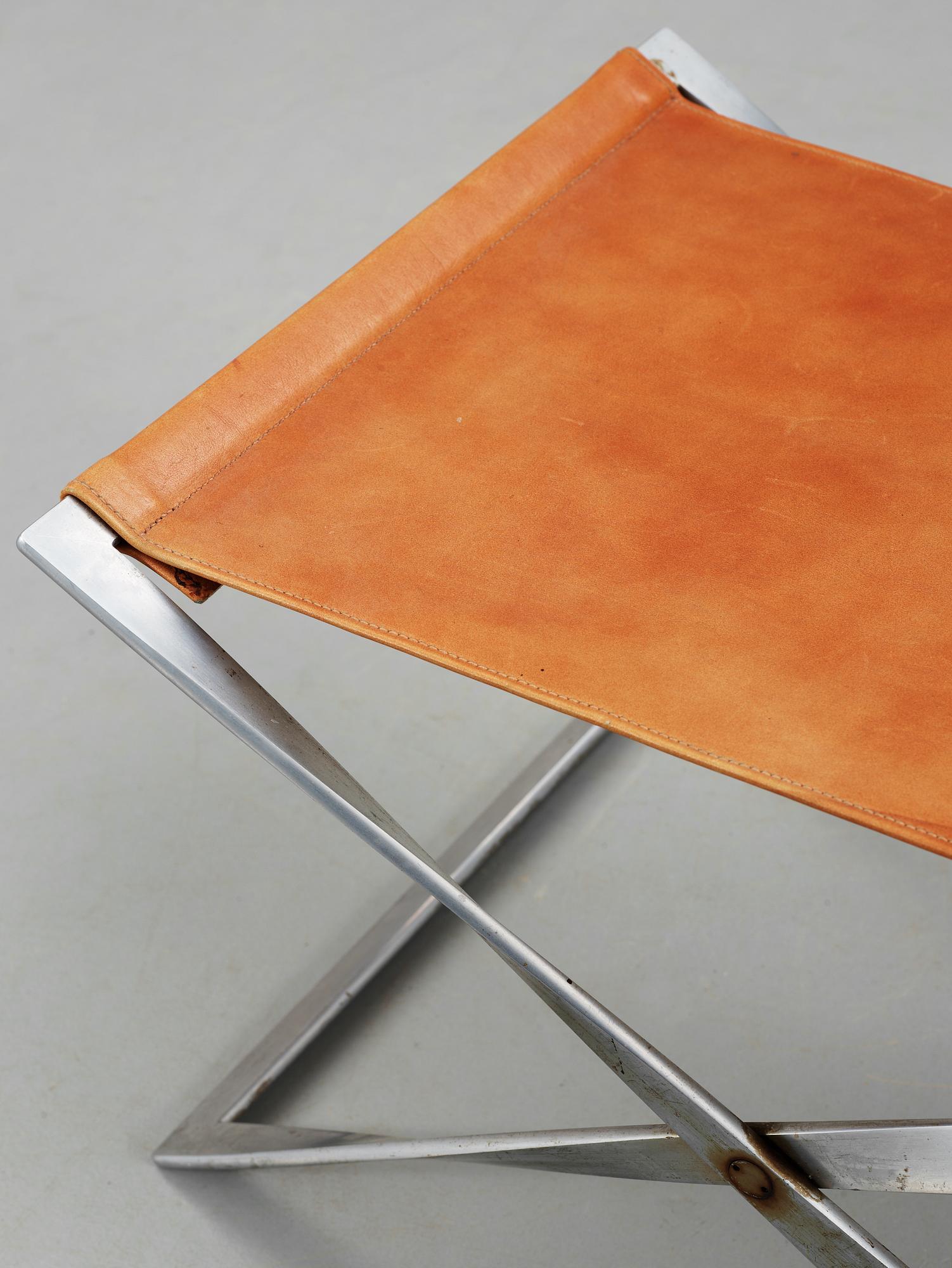 A Poul Kjaerholm 'PK-91' steel and brown leather stool, Fritz Hansen, Denmark.