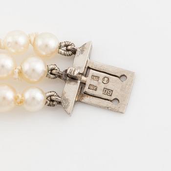 Three strand calibrated cultured pearl necklace, clasp with pearl and rose cut diamonds.