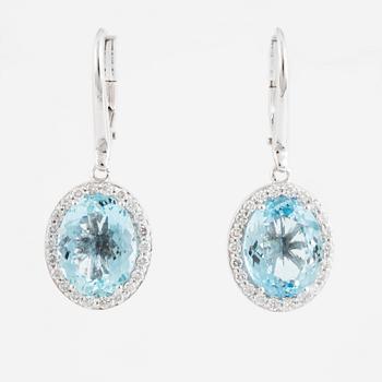 A pair of 18K gold earrings set with faceted aquamarines.
