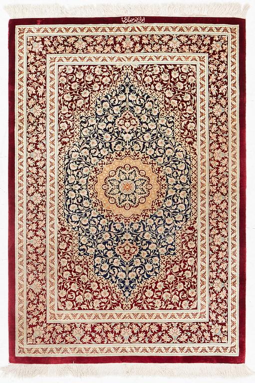 A rug, silk Quum, signed, c. 106 x 80 cm.
