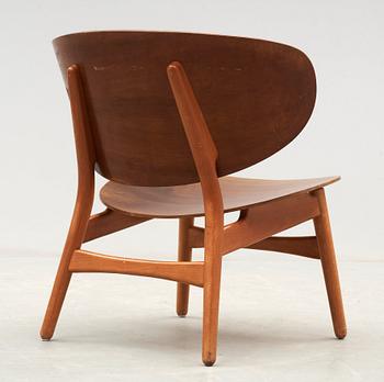 A Hans J Wegner mahogany and beech easy chair, Denmark 1950's.