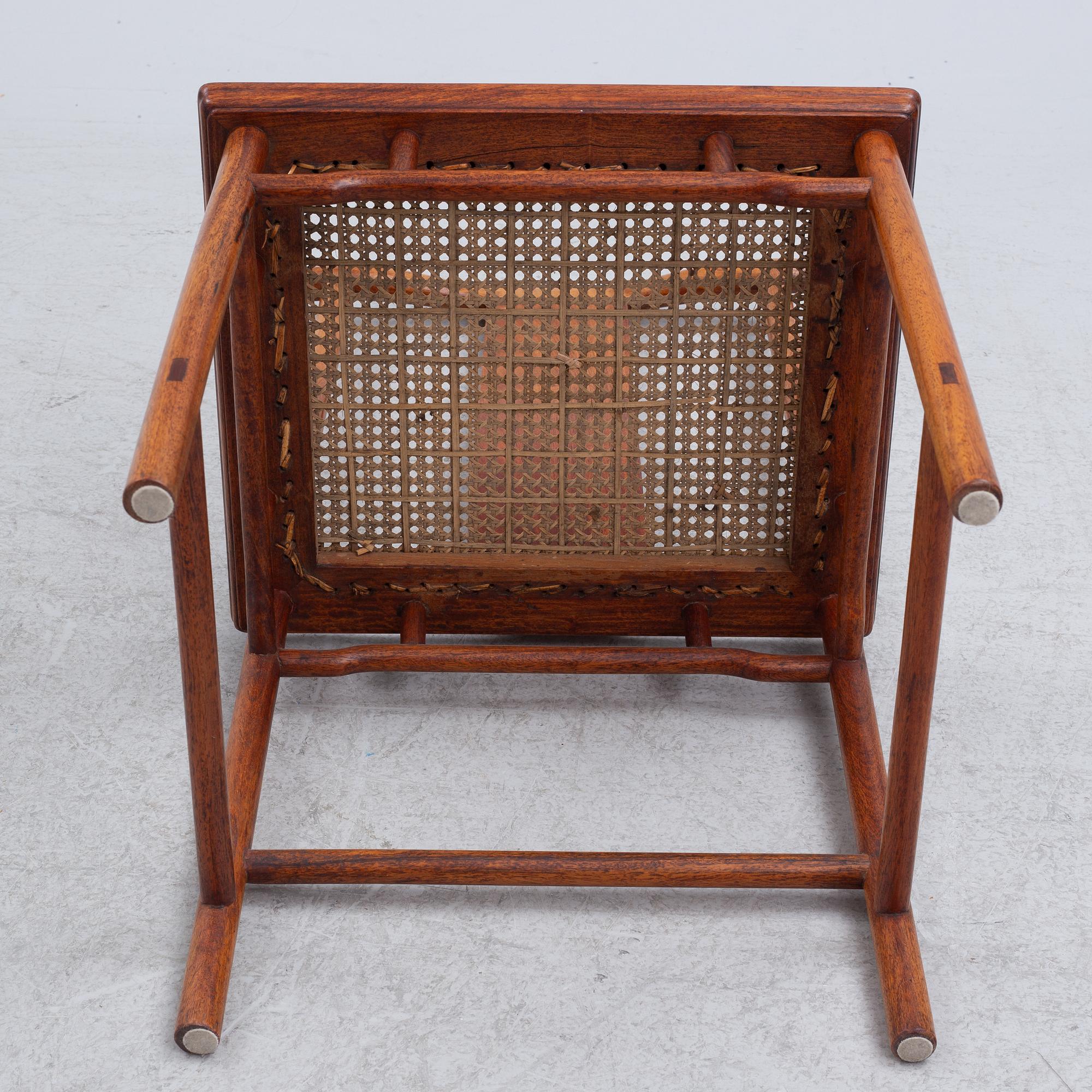 A Chinese hardwood dinner table and ten chairs with rattan seats, 20th century.