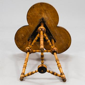 A wooden table from around 1900, cut decor.