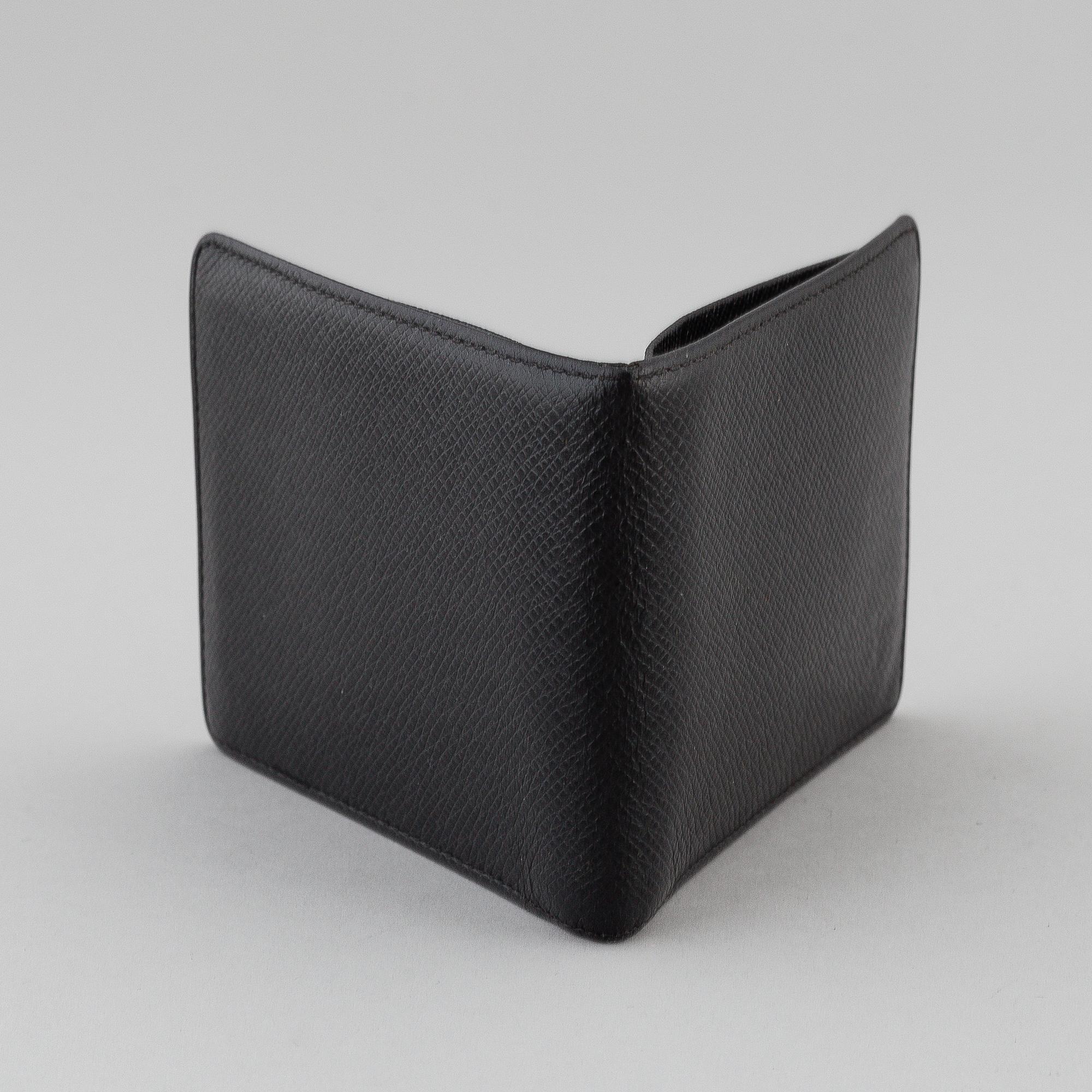 LOUIS VUITTON, black taiga leather wallet.
