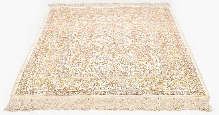 A silk Hereke rug, c. 112 x 74 cm.