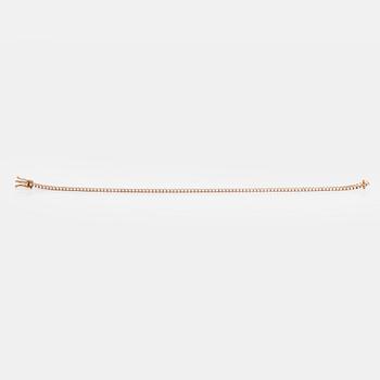 An 18K rose gold tennis bracelet with brilliant cut diamonds.
