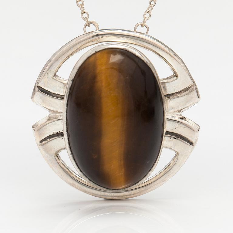 A silver ring and necklace with tiger's eye. Kultasepät Salovaara, Turku 1961.