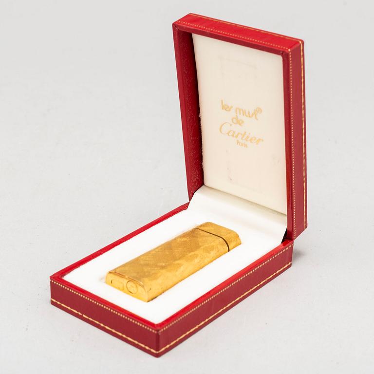 A gilt steel lighter from les must de Cartier.