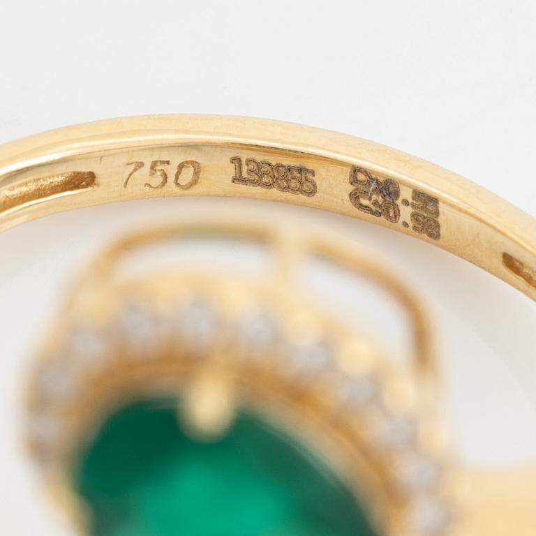 Emerald and diamond cross over ring.