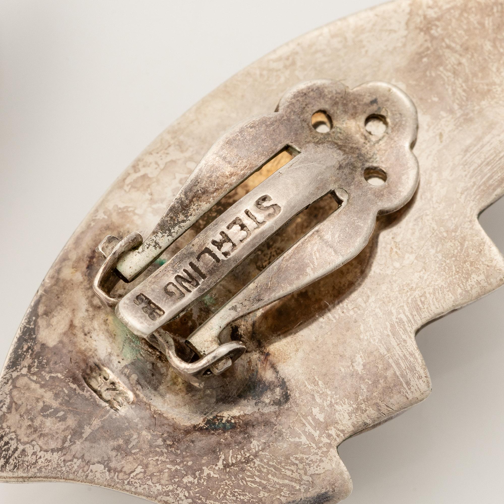 Earrings, silver, in the form of stylised leaves.