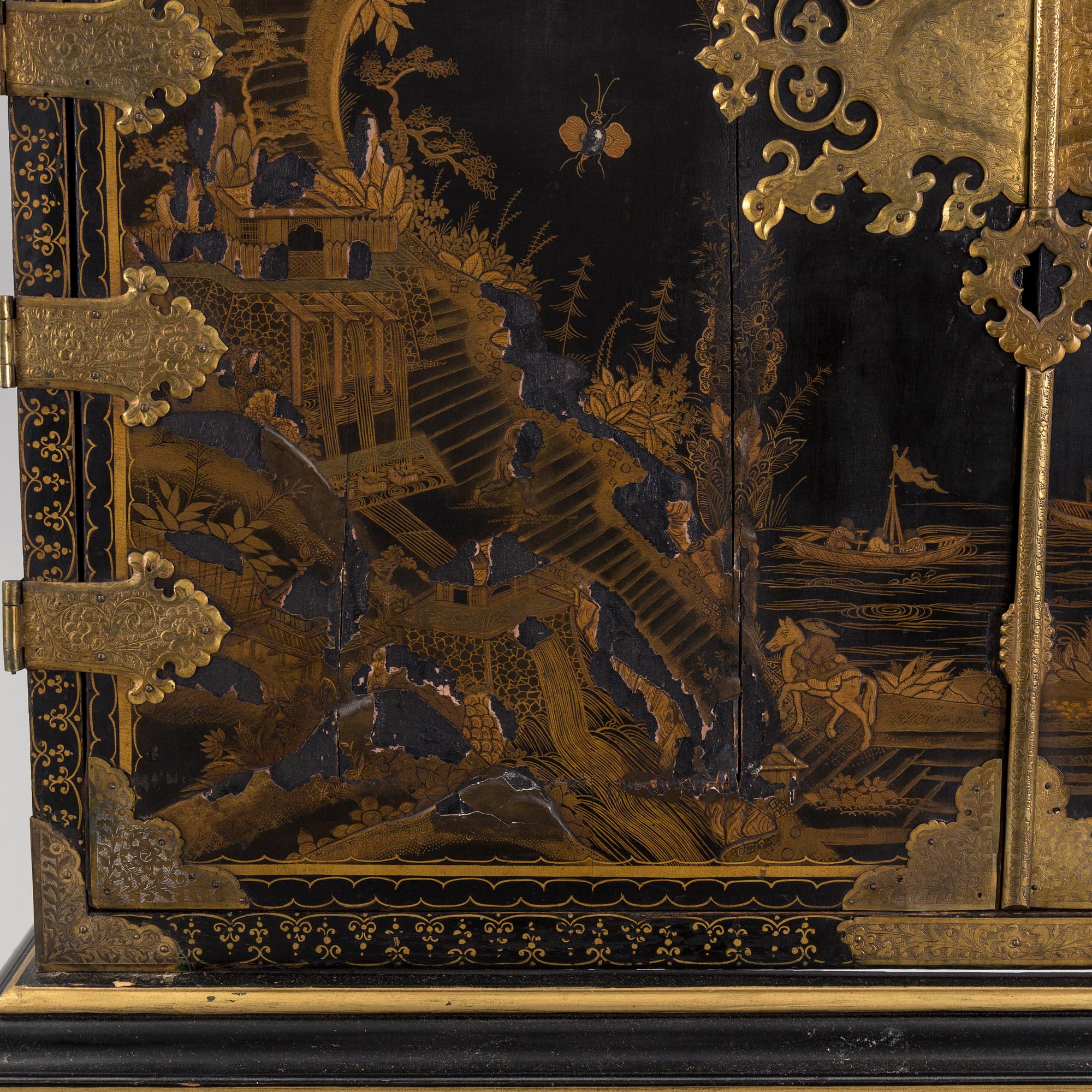 AN early 18TH CENTURY PROBABLY ENGLISH Japanned laquer cabinet on stand.
