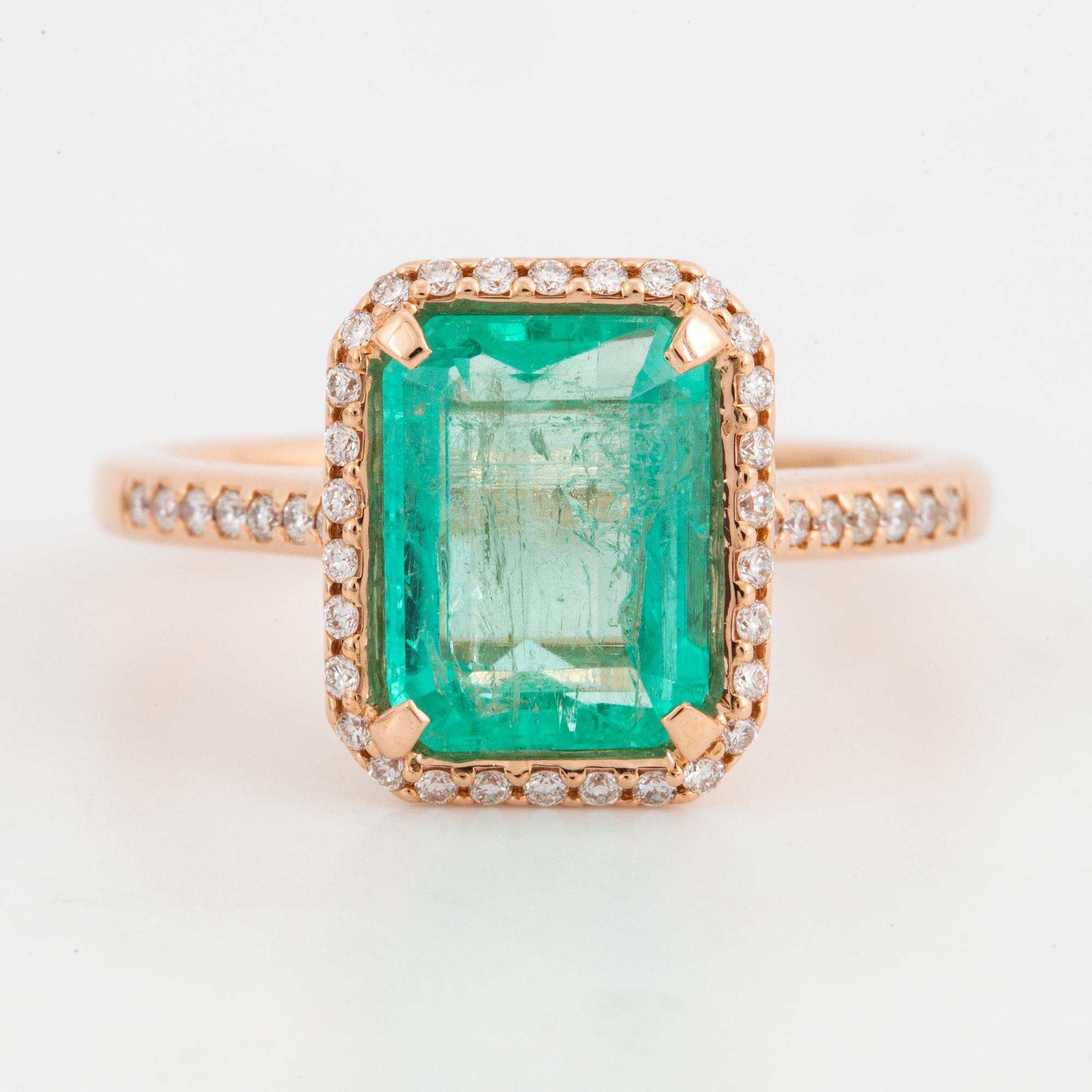 Emerald-cut emerald and brilliant-cut diamond ring.