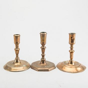 A set of five different brass late Baroque candlesticks.