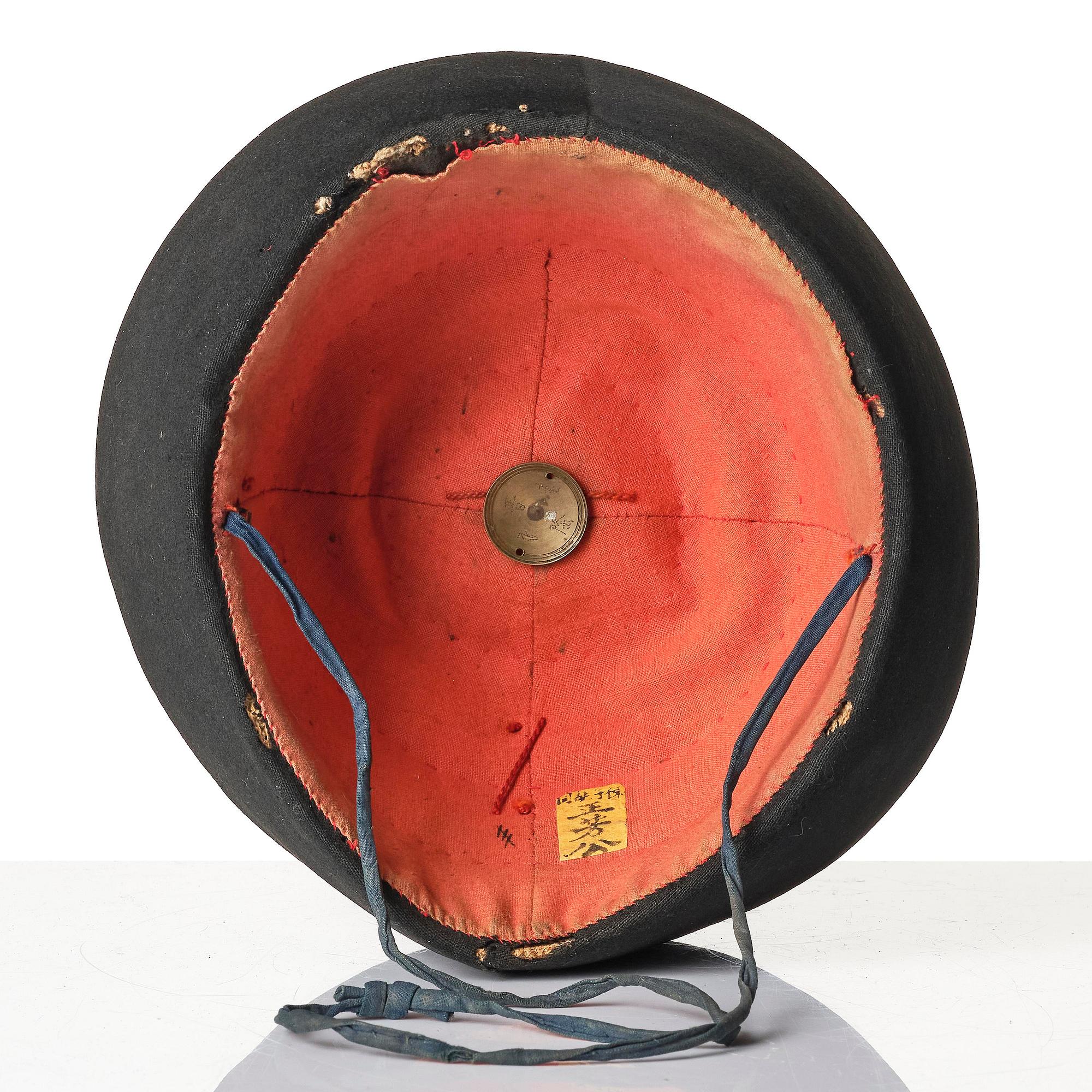 Two boxes with a mandarin's summer hat and black satin autumn hat and feather with six mandarin hat insignias.