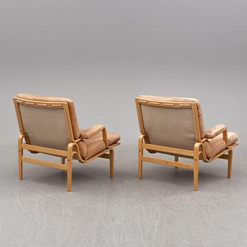 BRUNO MATHSSON, a pair of easy chairs with one stool.