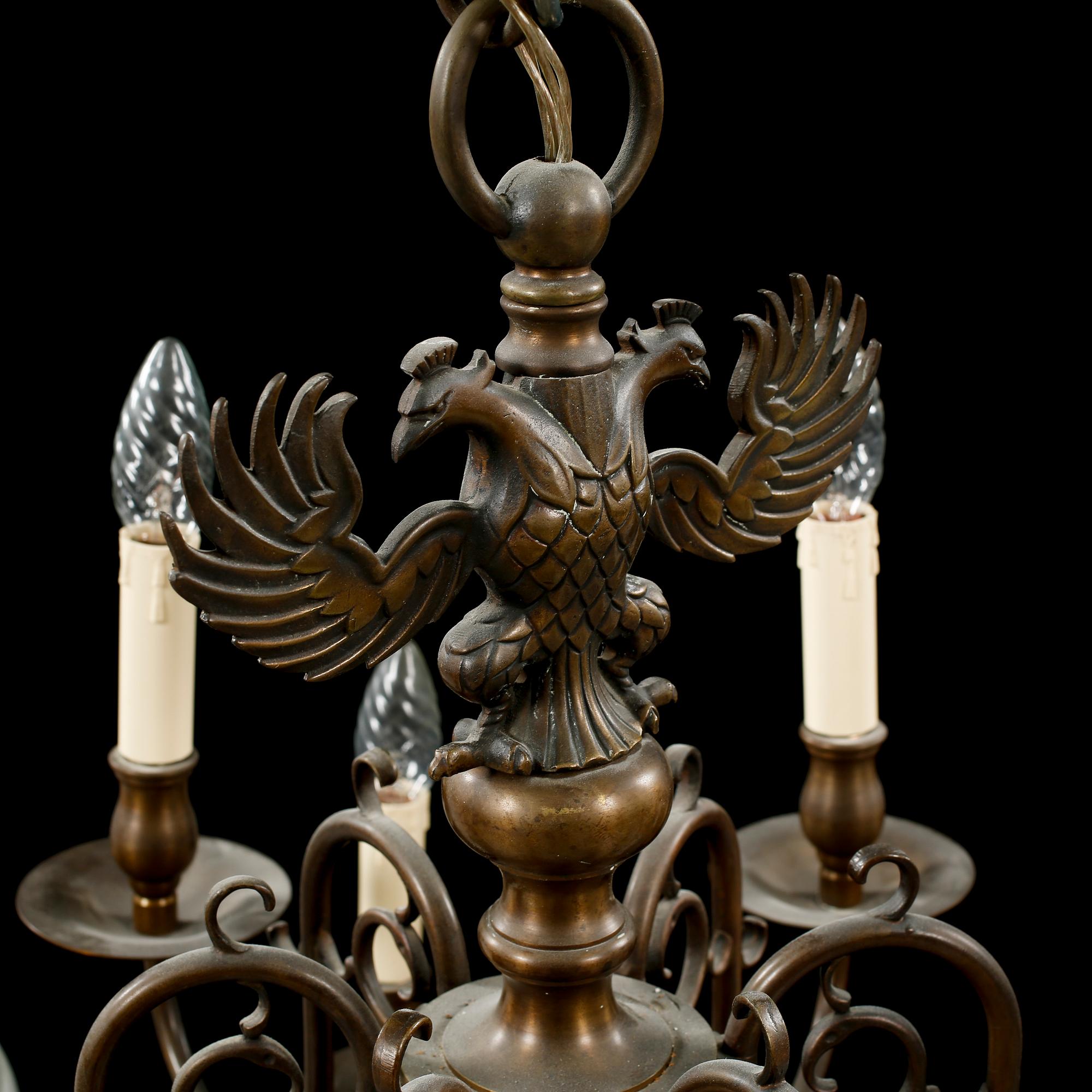 A patinated brass chandelier, first half of the 20th century. Height excl. chain ca 75 cm.