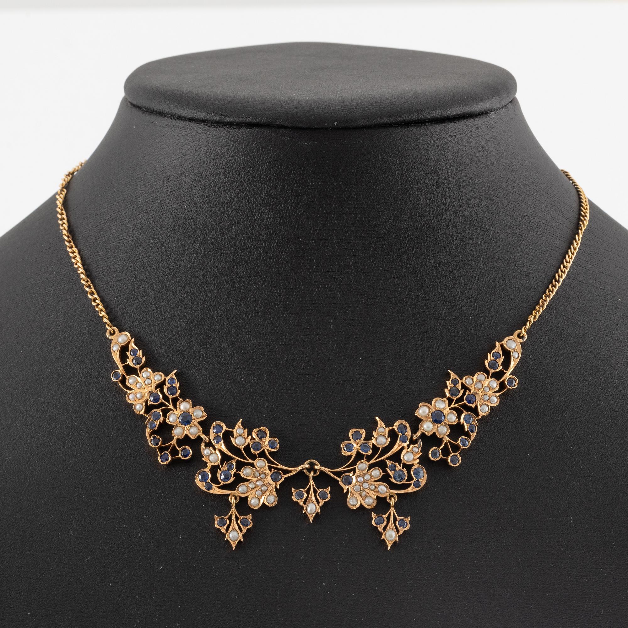 A 14K gold necklace with sapphires and pearls.